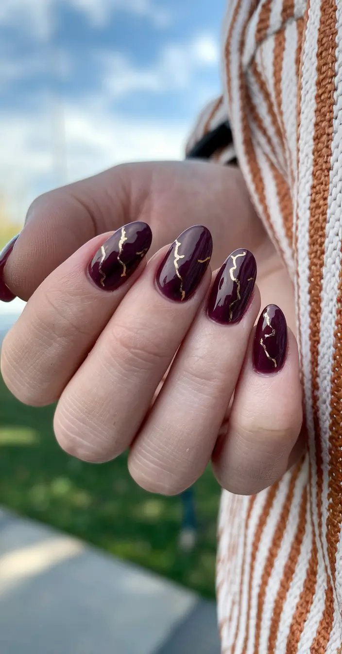 fall nails oval shape Merlot with Gold Veining