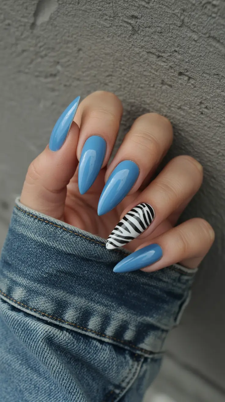 acrylic nail designs 2026 Soft Blue Almond With Zebra Accent Flair