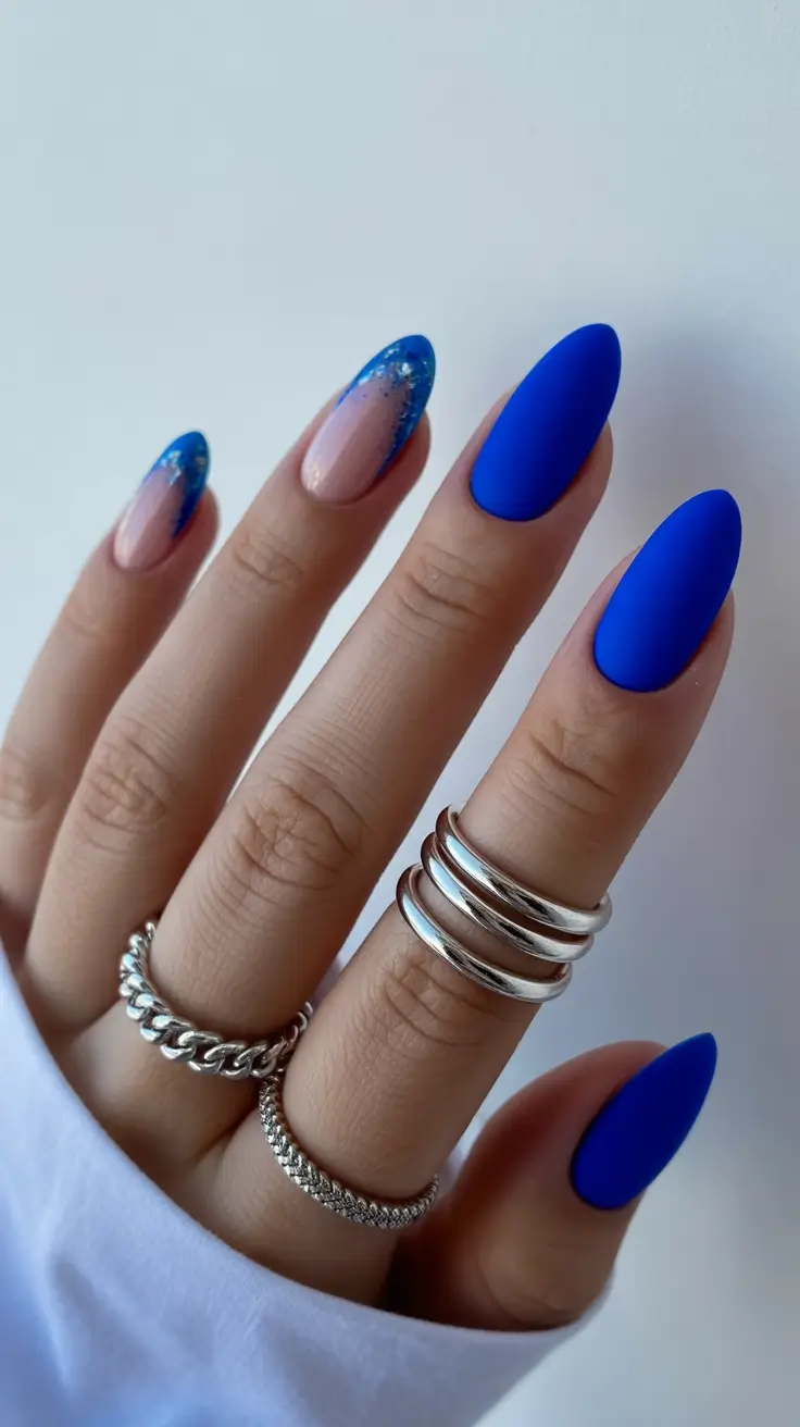 acrylic nail designs 2026 Matte Blue Almond with Glitter-Touched Tips