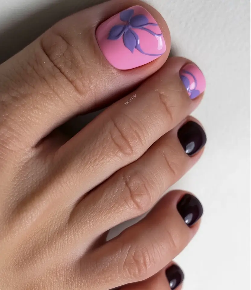 trendy spring toe nails 2026 Soft Pink Floral Pedicure with Dark Accent Contrast